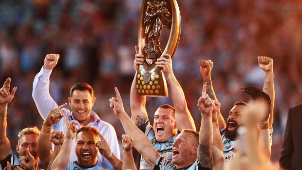 Long time in the making: Paul Gallen holds aloft the NRL premiership trophy. 