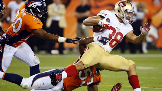 Another start: Jarryd Hayne is tackled by the Denver defence.