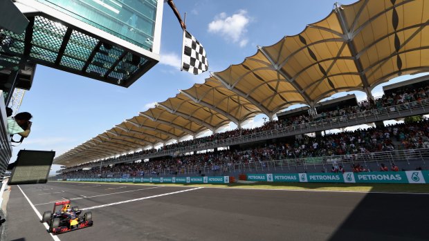 Line honours: Australia's Daniel Ricciardo takes the chequered flag.