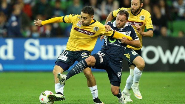 Anthony Caceres of Central Coast (right) and Leigh Broxham of Melbourne compete. 