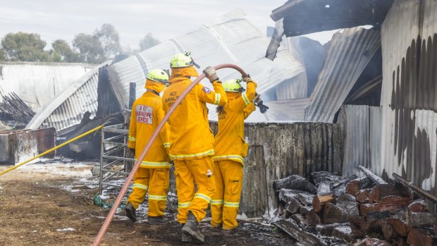 Firefighters mop up after a fire at Gold Creek Station near Hall destroyed the function centre.