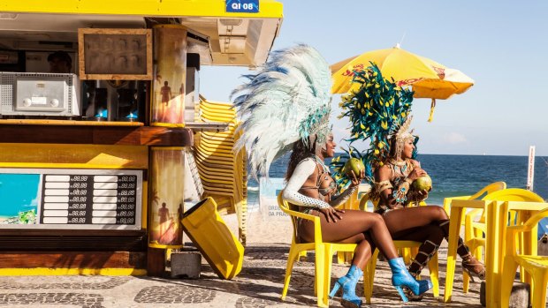 Samba dancers taking a break, Ipanema Beach, Rio De Janeiro, Brazil.