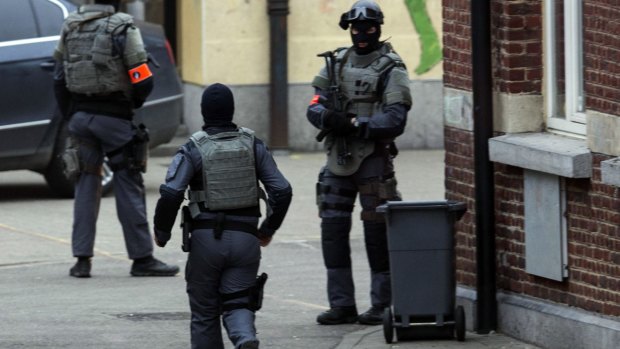 Special operations officers close down a street during a police raid in the Molenbeek neighbourhood of Brussels.