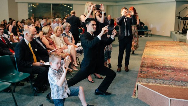 Split focus: Aisles bristling with smartphones can detract from the ceremony.