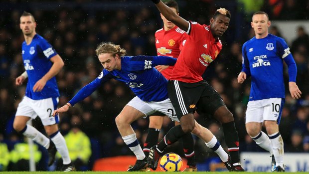 Everton's Tom Davies and Manchester United's Paul Pogba battle for the ball.