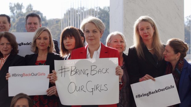 Concerned MPs, including shadow foreign minister Tanya Plibersek, display #bringbackourgirls signs outside Parliament House in Canberra in 2014.