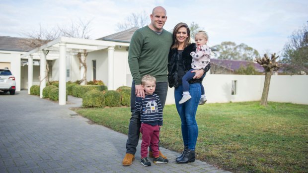 Stephen, Courtney, Theodore and Darcy Moore outside their Canberra home in Yarralumla.