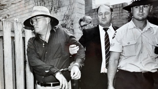David Harold Eastman is arrested and handcuffed  in December 1992. He was later convicted  the assasination of AFP Assistant Commissioner Colin Winchester. In the centre is Commander Rick Ninness.