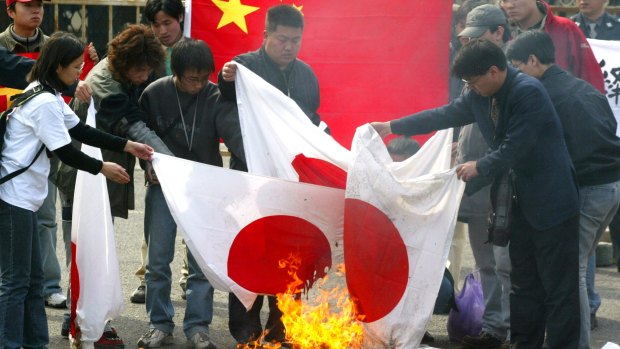 Chinese protesters burn a pile of Japanese flags in a file picture.