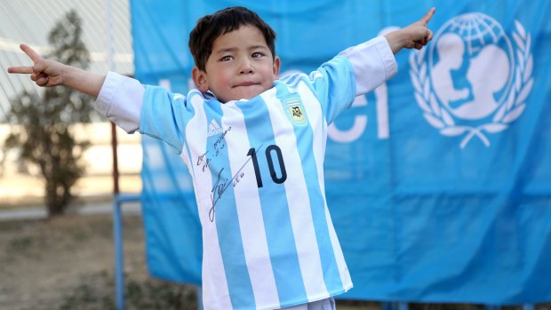 Murtaza Ahmadi shows off the signed shirt sent to him by Lionel Messi.