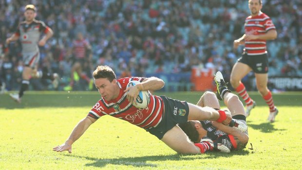 Flying: James Maloney touches down for the Roosters.