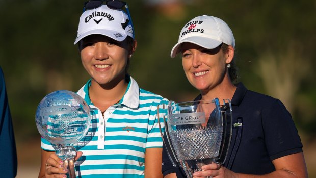 Lydia Ko, left, and Cristie Kerr hold their trophies.