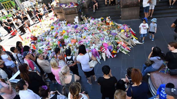 Tragic loss: The public lay flowers at Bourke street.