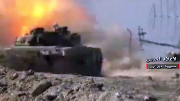 A Syrian army tank fires on an Islamic State position in north Syria, in this video still provided by the Syrian government.