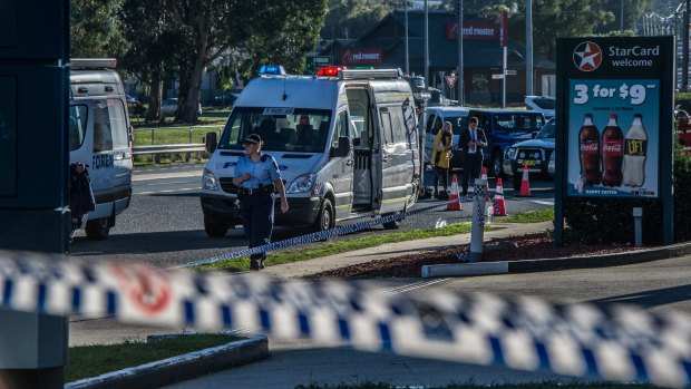 Police and emergency services at the scene of the Queanbeyan service station stabbing. 