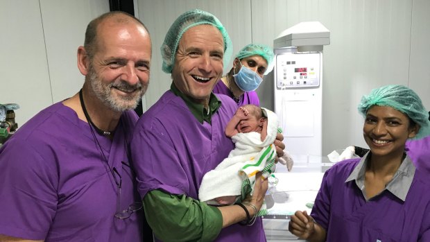 Medical staff welcome the first new arrival at an Australian-run field hospital near Mosul [from left]: Dr Werner Goldman, Dr Markus Huettl, Dr Ali and Priscilla Thajan.