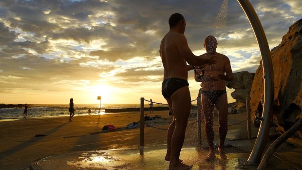 Swimmers rinse off after a swim at Clovelly Beach earlier this month.