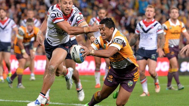 Caught in the middle: Anthony Milford of the Broncos.