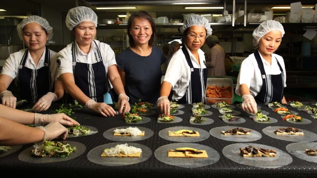 "I have lost my business. That's the biggest price to pay": Nahji Chu, owner and founder of MissChu, with some of her staff.