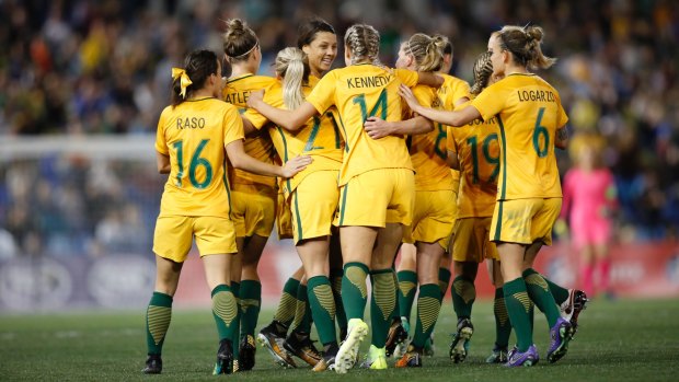 Good as gold: Matildas players celebrate Sam Kerr's first goal of a brace.