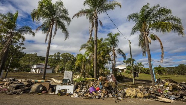 Damaged belongings line a street at Eagleby, south of Brisbane, in the wake of Cyclone Debbie.