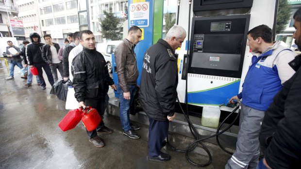 People line up for fuel at a petrol station in Istanbul during a major power outage.