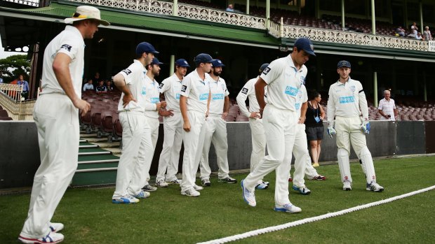 Solemn occasion: Blues captain Moises Henriques leads his side onto the field after players observed a moment's silence for the late Phillip Hughes.