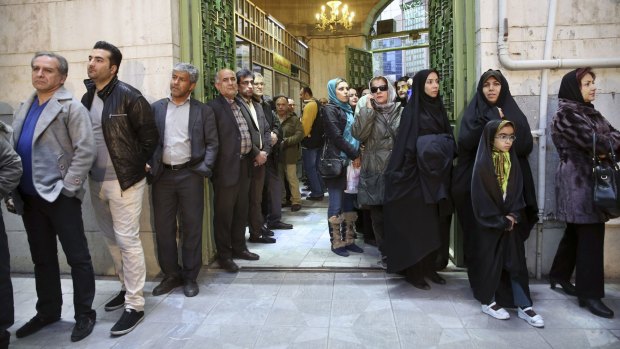 Iranians queue for voting in the parliamentary and Experts Assembly elections in a polling station in Tehran.