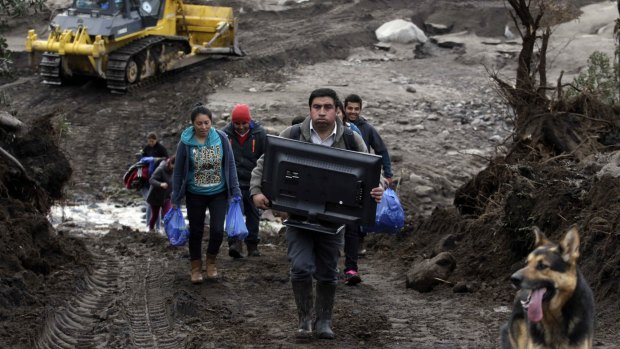 Residents evacuate after their home was destroyed by a volcanic mudflow in Puerto Montt, Chile.