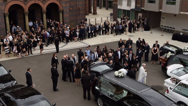 The crowd gathers outside the church after the funeral of Annabelle Falkholt and her parents Lars and Vivian Falkholt at St Mary's Catholic Church, Concord, Sydney.
