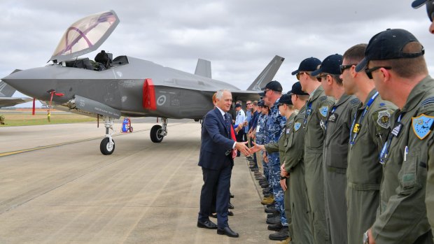Welcome aboard: Prime Minister Malcolm Turnbull shakes hands with Defence Force members at the first outing of Australia's newest warplane, the F-35 Joint Strike Fighter