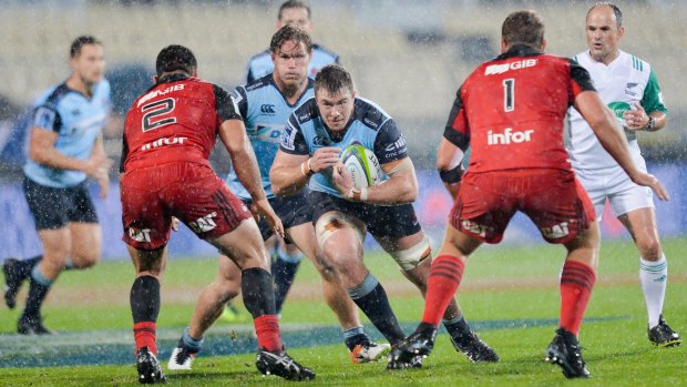 Tough night at the office: NSW forward Jed Holloway got a lesson in No.8 play from the Crusaders' Kieran Read in Christchurch on Friday night. 