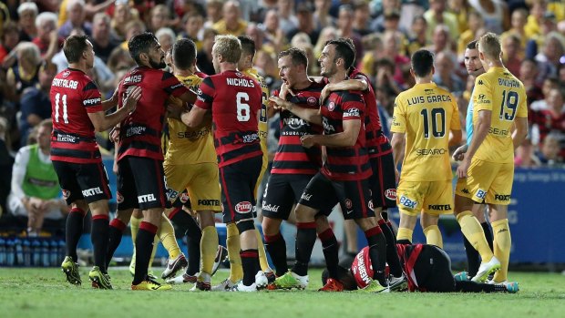 Angry reaction: Wanderers and Mariners players clash after the tackle.