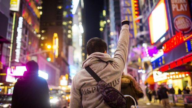 A demonstrator raises a fist during a protest at midtown Manhattan. 