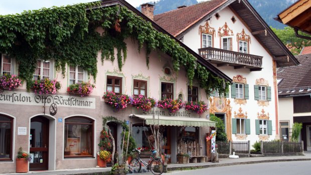 Traditional alpine buildings with frescoes.
