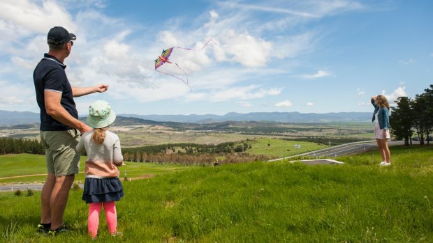 Justin Smith, Selita Canton-Smith, 3, and Isabella Smith, 15 fly a kite at the National Arboretum Forest open day.
