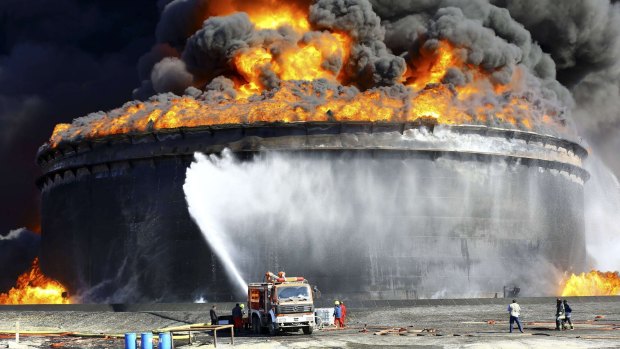 Firefighters try to put out a blaze in a storage tank at the key Libyan port of Sidra last week.