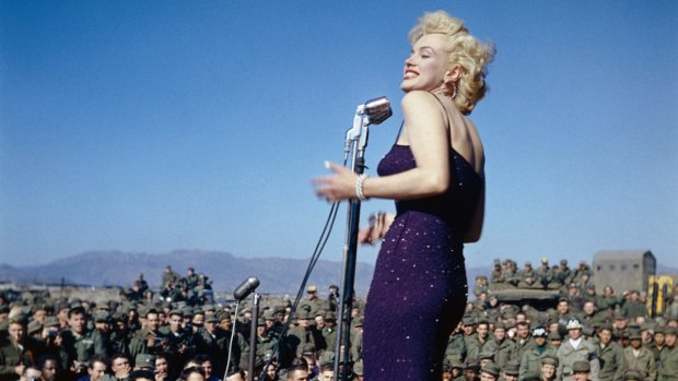 Marilyn Monroe singing to the troops in Korea in 1954. She made the trip as part of her honeymoon with Joe DiMaggio.