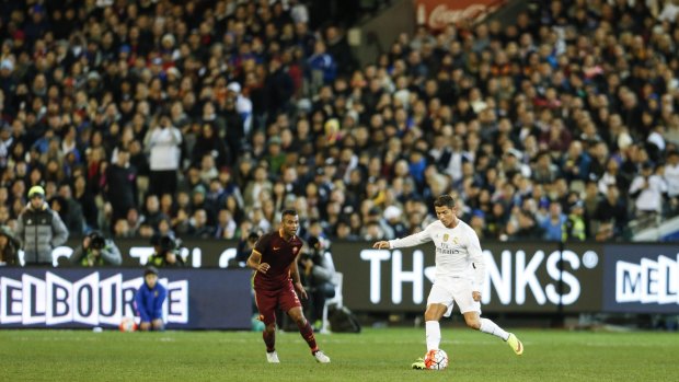 Global icon: Cristiano Ronaldo controls the ball in front of a packed crowd at the MCG.