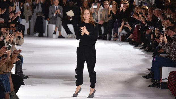 Stella McCartney accepts applause after her show at Paris Fashion Week on Monday.