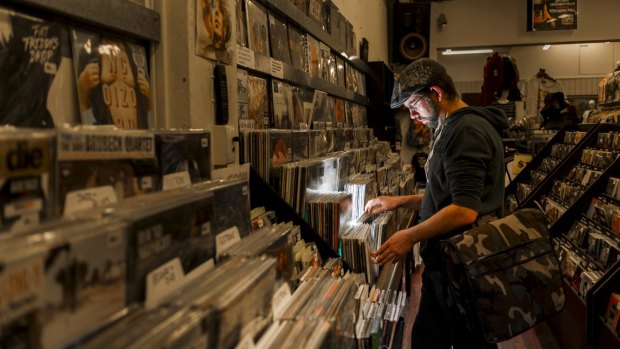 Local part-time DJ Colin McLeod looks through records at Landspeed Records in Garema Place.