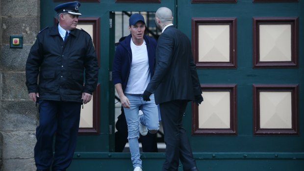 Oliver Curtis looking startled as he's released from prison and greeted by the media contingency.