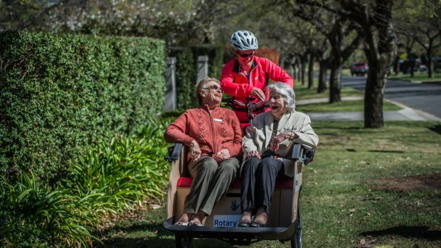 Adrienne Capp, 80 and Beryl Hunter, 99, piloted by Caroline Fargher of Pedal Power. 