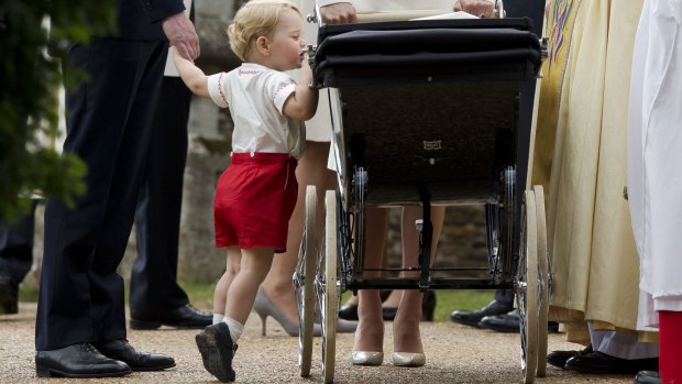 Prince George checks out his little sister on Princess Charlotte's Christening day.