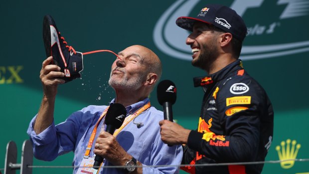 Actor Patrick Stewart does a 'shoey' on the podium with Daniel Ricciardo.