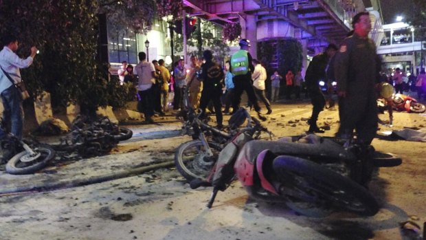 Motorcycles are strewn about after an explosion at a central Bangkok intersection during the evening rush hour, killing a number of people and injuring others, police said. 