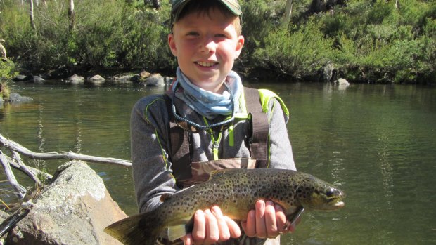 Eleven-year-old Michael Vincent with a trout caught near Yaouk.