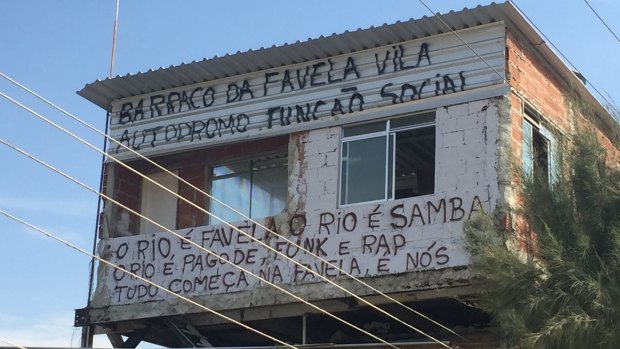One original house was allowed to remain at Vila Autodromo. The graffiti states: "Social purpose hut of Vila Autodromo favela" and "Rio is favela, Rio is samba, Rio is pagode, funk and rap. Everything starts in favelas. It is us".