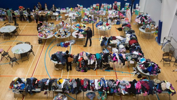 People evacuated due to wildfires in the Fort McMurray area browse through clothing donations and other supplies at a community centre in Lac La Biche, Alberta, on Thursday.