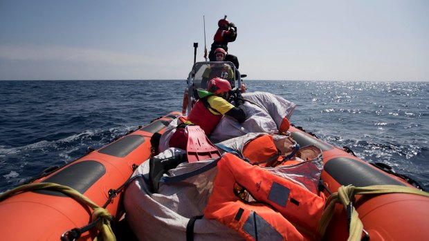 Proactiva Open Arms crew conduct a search and rescue operation in the Mediterranean sea, 12 nautic miles from the Libyan coast, Thursday, April 13, 2017.